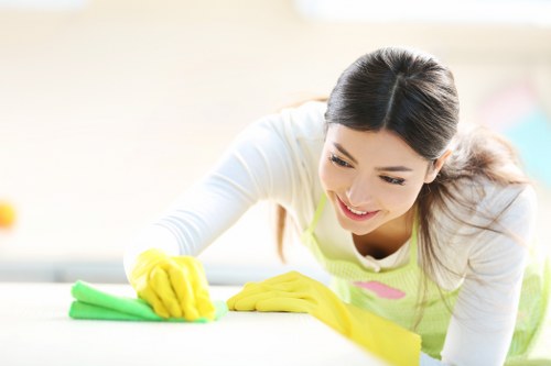 Technician performing steam carpet cleaning in a commercial hallway
